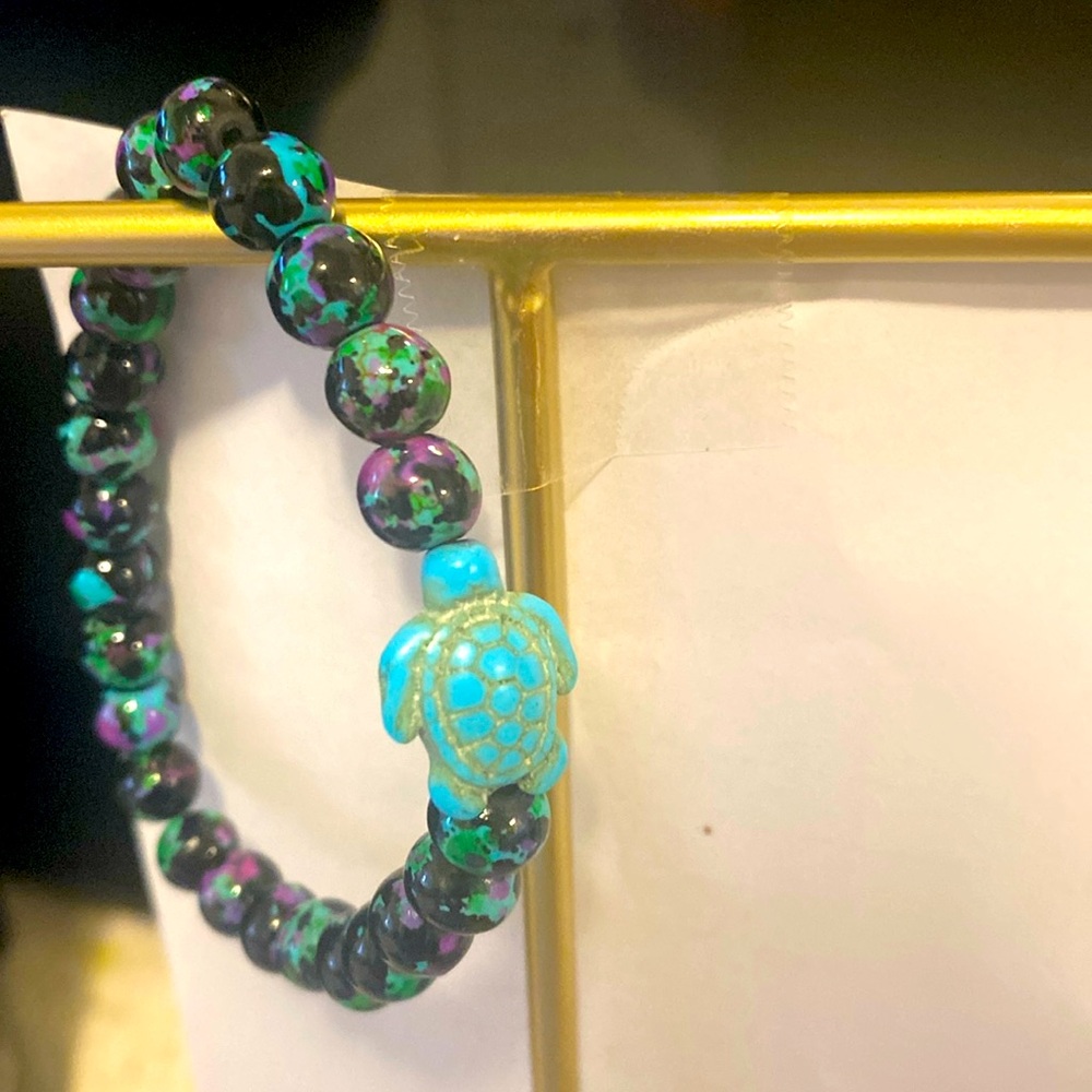 Sea turtle bracelet is turquoise color and the beads are turquoise brand new